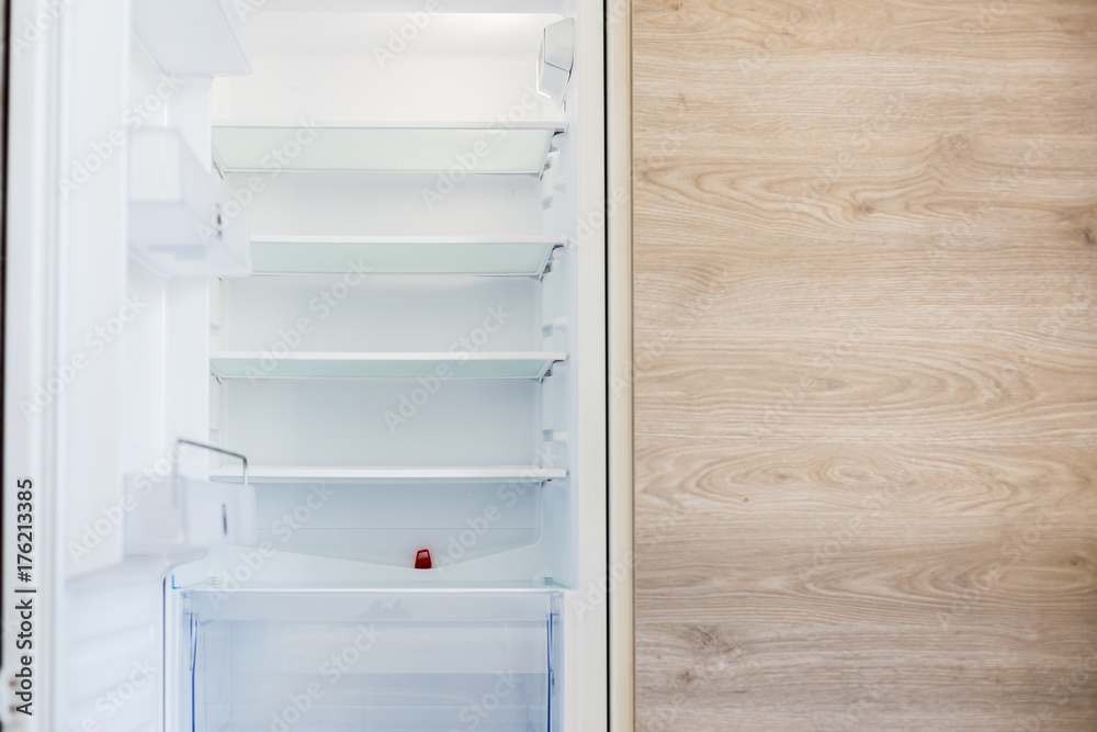 Empty new fridge, front view photo with the wooden kitchen texture ...