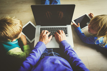 Wall Mural - father with kids using laptop and tablet