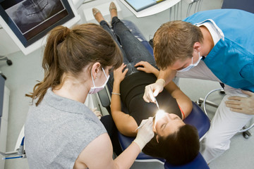 Wall Mural - Dentist with patient and assistant