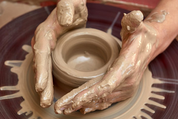 Wall Mural - Creating jar or vase of clay. Woman hands, potter's wheel