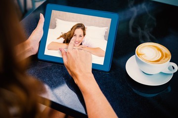 Poster - Composite image of woman having coffee and using her tablet