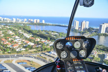 View from a helicopter cockpit flying over Rio de Janeiro. Cockpit with instruments panel.