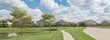 Walking pathway alongside leads to residential houses by the lake in Pearland, Texas, USA. Panorama style.