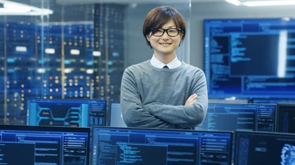 Fototapete - In the System Control Room IT Technician Crosses Arms and Smiles. He's Surrounded by Multiple Displays Showing Graphics. 