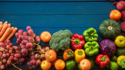 Wall Mural - Flat lay of fresh  fruits and vegetables for background, Different fruits and vegetables for eating healthy, Colorful fruits and vegetables on blue plank background