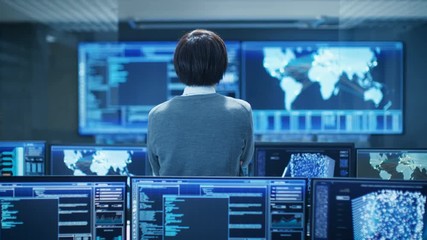 Fototapete - In the System Control Room Technical Operator Stands and Monitors Various Activities Showing on Multiple Displays with Graphics. Artificial Intelligence, Big Data Mining, Neural Network.