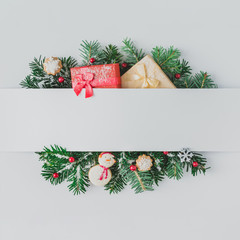creative layout made of christmas tree branches with decoration and snow. flat lay. nature new year 