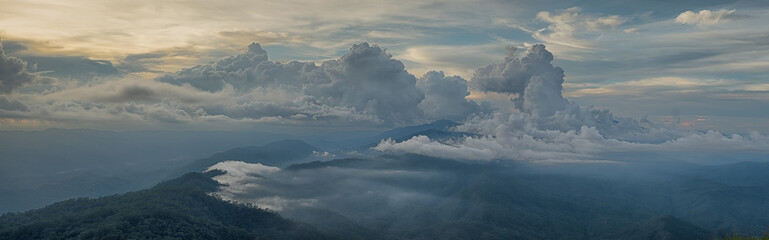 Panorama beautiful of the forests, mountain and fog in the evening sunshine. at Doi Luang Tak, Tak Province,Thailand. subject is blurred.