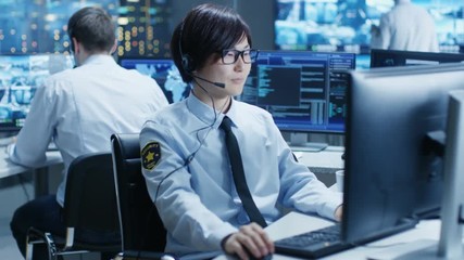 Aufkleber - In the Security Command Center Officer at His Workstation Monitors Screens and Communicates with Patrols through Headset. He is Part of the Surveillance Team. 
