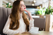 © speed300 - Beautiful young girl with professional makeup and hairstyle sitting in restaurant.