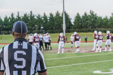 Referee watching Football