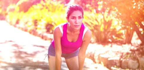 Tired woman taking break while jogging