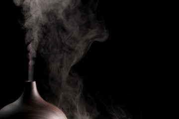 alternative spa therapy device. electric essential oil aromatherapy diffuser producing vapor.