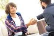 © ASDF - manager shakes hands with his client