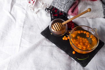 Wall Mural - tray with honey and a cup of hot tea in the bed,