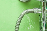 Fototapeta  - Damaged leaking water tap hose in the bathroom of house, flat or other place. Plumbing concept.