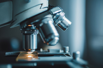 close-up shot of microscope with metal lens at laboratory.