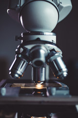 Wall Mural - close-up shot of microscope with metal lens at laboratory.