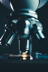 Wall Mural - close-up shot of microscope with metal lens at laboratory.