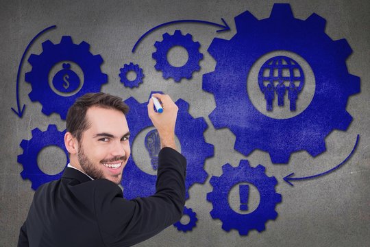 Composite image of happy businessman writing with marker