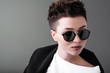 © speed300 - Portrait of a young beautiful girl in sunglasses against a dark background