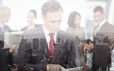 Poster - Mature businessman using digital tablet