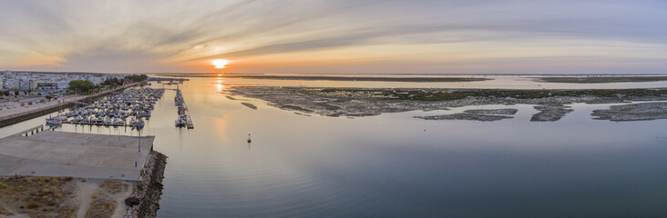 Sunrise aerial seascape view of Olhao Marina, waterfront to Ria Formosa natural park. Algarve.