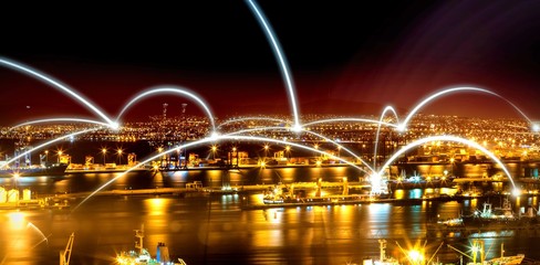Poster - Illuminated harbor against cityscape