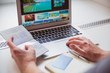 © Myroslava - Photography of laptop which using man and keeping passport in hand indoors