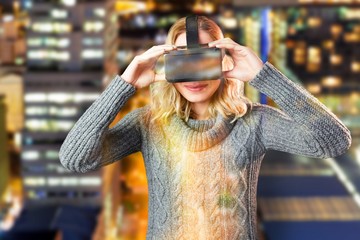 Poster - Composite image of smiling blond woman using virtual reality