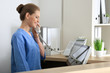 © Africa Studio - Young female receptionist talking on the phone in hospital