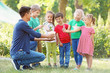 © Africa Studio - Group of children with teacher in park on sunny day