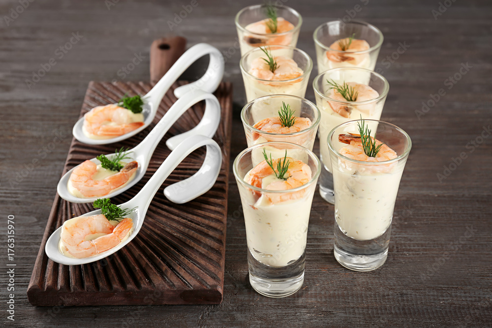 Composition with tasty shrimps and white sauce on table