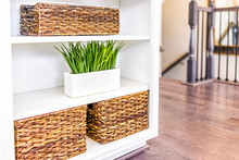 Closeup Of White, Modern, Minimalist Shelves In Kitchen Or Living Room With Woven Baskets And Green Plants Pots, Containers