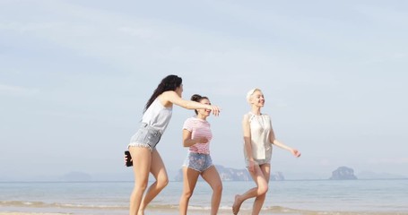 Wall Mural - Happy Girls Walking On Beach Jumping, Cheerful Young Women Group Tourists Slow Motion 60