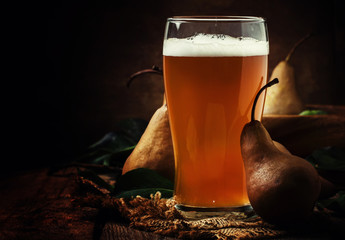 Wall Mural - Pear cider in a large beer glass, vintage wooden background, selective focus