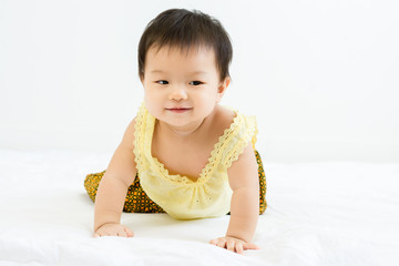 Canvas Print - Portrait of adorable baby girl crawling on the bed, indoors