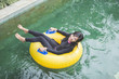 © Odua Images - young woman enjoying tubing at lazy river pool