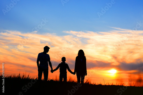 Happy Family Together At Sunset Silhouette Of Parents And Son