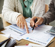 © Rawpixel.com - Pensioner filling out aform