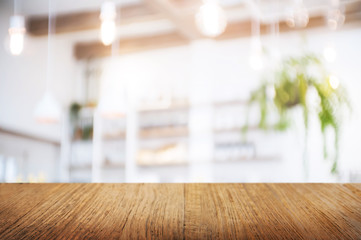 empty wood table over blurred montage coffee shop or kitchen background