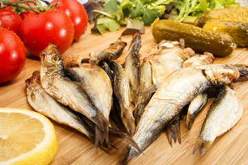 Wall Mural - smoked sprats with salad, tomatoes, a slice of lemon and gherkin