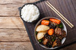 © FomaA - Korean stewed beef short ribs with vegetables and rice garnish close-up. Horizontal top view
