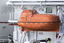 Orange Inclosed Lifeboat Hung From Davits An A Ship