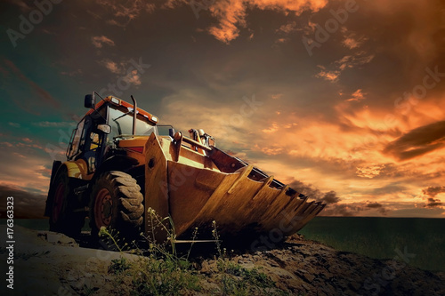 Fényképezés Yellow tractor on sky background