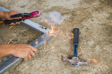 Welder working  in an industrial setting manufacturing steel equipment