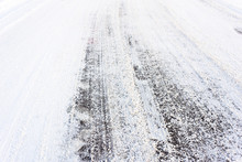 Country Road In Winter , Asphalt Covered Snow With Tire Tracks, Transportation Concept