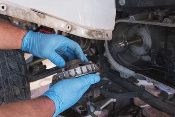 Hand with tools, Professional mechanic repair and modifications to ATV