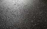 Wet asphalt road after the rain. Asphalt background. Asphalt perspective.  Background and texture. Sun reflection Stock Photo