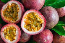 Fresh Passion Fruit On Wood Table In Top View Flat Lay For Background Or Wallpaper. Ripe Passion Fruit So Delicious Sweet And Sour. Close Up On A Half Of Passion Fruit In Macro Concept.Tropical Fruit.